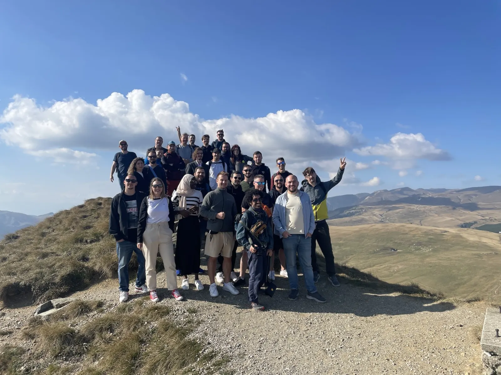 Friendly.rb attendees posing on a mountain summit on the Friday trip